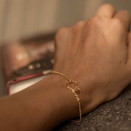 The Place Map Bracelet Australia map outline in gold vermeil on a model, leaving gift