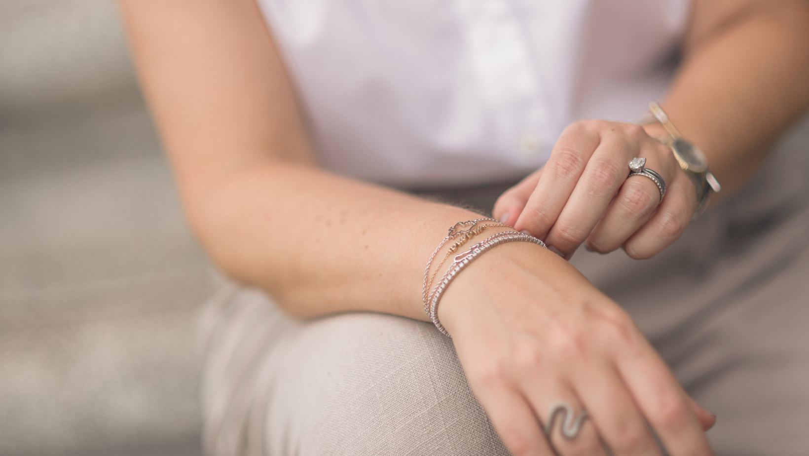The Place founder map bracelet stack